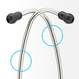 Shiny aluminum eartubes of a 3M Littmann Stethoscope symmetrically crossing each other, with black eartips on the ends. 